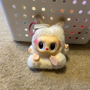 White labubu plush doll sitting the monster